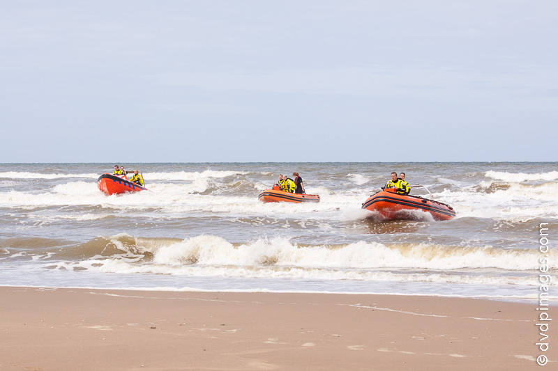 Someone is taken to the beach using small boats.